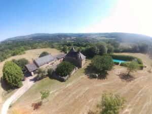 an aerial view of an old house on a field at La Coudonie in Sarrazac