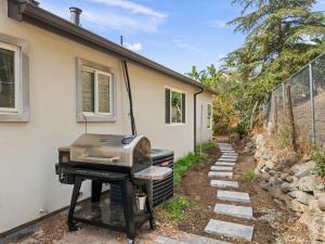 a grill outside of a house with a building at Newly Constructed Priv. Entry Master Suite in San Jose