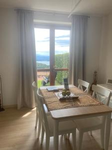 a dining room table with a view of a window at Casa Leone in Massino Visconti