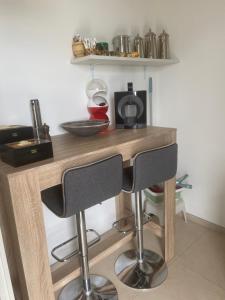 a wooden table with two bar stools in a kitchen at Casa Leone in Massino Visconti