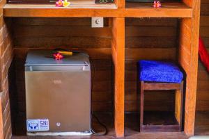 a computer under a desk with a chair underneath it at Bagus Dream Beach Villa Lembongan in Nusa Lembongan