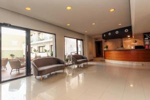 a lobby with chairs and a bar in a building at Hotel Lauria in Tarragona