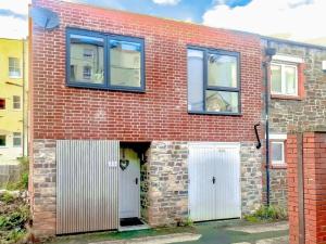 a brick house with two white doors and windows at Chic Clifton Home – inviting décor & outdoor space in Bristol