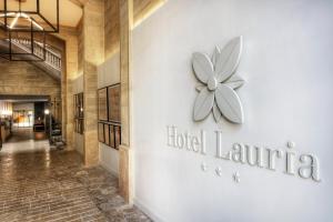 a hotel lobby with a clock on the wall at Hotel Lauria in Tarragona