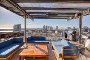 a balcony with couches and tables on a building at East Village 1br w spa media room nr stadium SAN-37 in San Diego