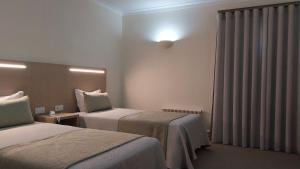 Cama ou camas em um quarto em Hotel Santa Maria