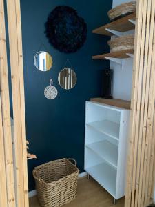 a room with a blue wall with shelves and lights at L'appart Duplex in Le Havre