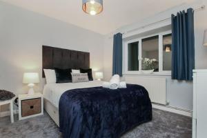 a bedroom with a large bed and a window at Hurrell House in Boreham