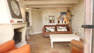 a living room with a couch and a fireplace at Les Rochettes in La Garde-Adhémar