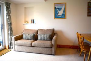 a living room with a couch and a table at The Little House, Wadebridge, Cornwall in Wadebridge