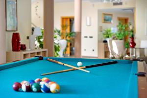 a pool table with three balls and cue sticks at Villa Rossella By Paramount Holidays in Adeje