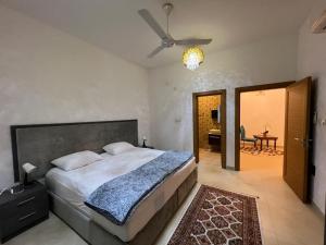 a bedroom with a bed and a room with a table at Muscat Seaside House in Muscat
