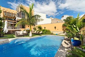 a swimming pool in the yard of a house at Villa Rossella By Paramount Holidays in Adeje