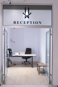 an office with a desk and a sign that reads reception at HASS Boutique Hotel in Gostivar