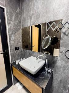 a bathroom with a sink and a mirror at HASS Boutique Hotel in Gostivar +57 photos