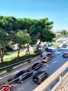 a group of cars parked on a road with trees at Ζεστό παραδοσιακό σπιτι in Kalamata