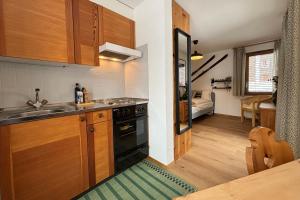 a kitchen with a sink and a stove at Charming studio, Bettmerhorn view in Bettmeralp