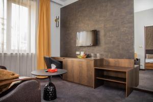 a hotel room with a desk and a tv at Cascade Hotel in Yerevan