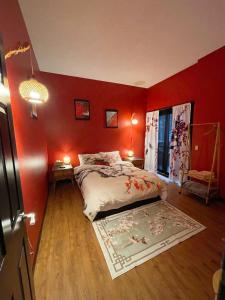 a bedroom with red walls and a bed with a rug at Lu Yao Inn in Calgary
