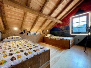 a bedroom with two beds and a window in it at La Maison de Marie in Saint-Julien-en-Born +108 photos
