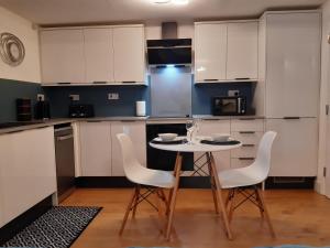 a kitchen with a table and chairs in a room at No's 2 and 5 Llewelyn Apartments in Llanberis
