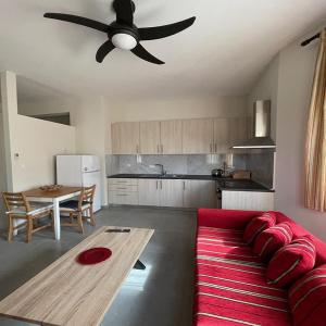 sala de estar con sofá rojo y ventilador de techo en Belvedere 1, en Drama