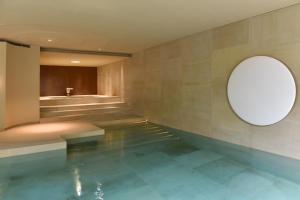 a bathroom with a swimming pool and a mirror at Yellison at Broughton Sanctuary in Skipton