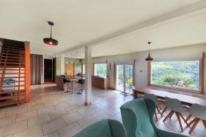 a living room with a table and chairs at La Bergerie du Pré de l'Orme - Avec vue montagne in La Bresse