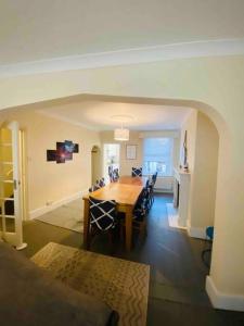a dining room and living room with a table and chairs at 7 Bedroom House in Town Centre near Beach - Sleeps 13 in Hastings
