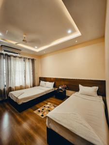 a room with two beds in a room at HOTEL OCEAN in Lumbini