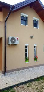 a house with a air conditioner on the side of it at VA Vikendica in Tešanj