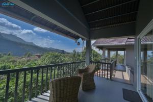 a balcony with chairs and a view of the mountains at Clouds View Nature Resort in Koroth