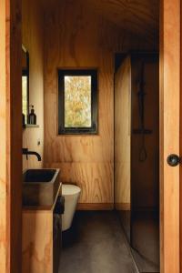 a bathroom with a tub and a sink and a window at Tawny in Kelsall