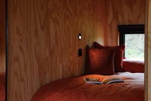 a bedroom with a bed with two books on it at Sirius in Kelsall