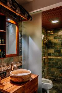 a bathroom with a sink and a toilet at 26Life Ethnic Trail Yunnan Ethnic Creative Inn in Jinghong