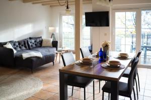 a living room with a table and chairs and a couch at JS-Apartments in Balingen