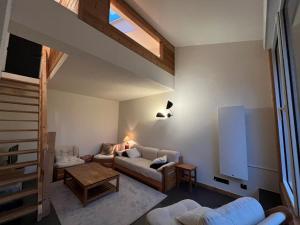 a living room with a couch and a table at Appartement Corrençon-en-Vercors, 3 pièces, 8 personnes - FR-1-761-3 in Corrençon-en-Vercors