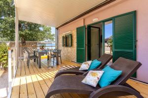 a patio with a table and chairs on a deck at Camping Glavotok in Krk