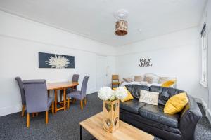 a living room with a couch and a table at Bright & Sunny 2BR Near Westcliff Beach & High St by Everhome Ltd in Southend-on-Sea
