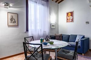 a living room with a table and a couch at Arno River Quiet Apartment in Florence