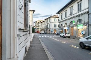 a city street with cars driving down the street at Arno River Quiet Apartment in Florence