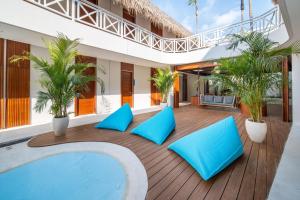 a pool in the middle of a house with blue pillows at IZE Canggu by LifestyleRetreats in Canggu