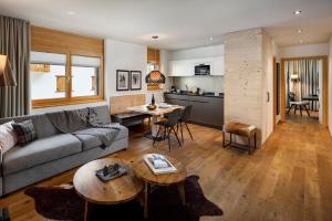 a living room with a couch and a table at Chalet Piz Buin in Klosters