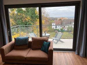 a living room with a couch and a large window at Klapka 08 in Prague