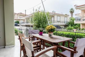a wooden table and chairs on a balcony at Va Yia/ Spacious guest house in Nafplio