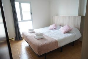 a bedroom with a bed with towels on it at Tábata playa in Gáldar