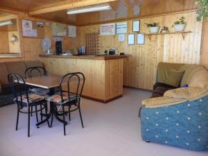 a room with a table and chairs and a counter at Hostal Alce in Nigrán