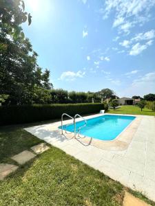 a swimming pool with a metal rail in a yard at La Casa da Pipa in Cesuras