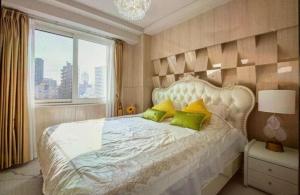 a bedroom with a large white bed with green pillows at Reimi Mondo701 in Tokyo