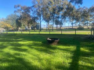 a boat sitting in the grass in a field at Hideaway Homestead in Nagambie